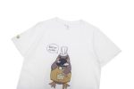 A white cotton t-shirt featuring a graphic of a platypus chef with a speech bubble. It has a logo on the sleeve.