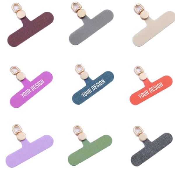 A collection of cell phone lanyard patches in various colours, each featuring a gold clip and customizable design spaces. A collection of cell phone lanyard patches in various colours, each featuring a gold clip and customizable design spaces.