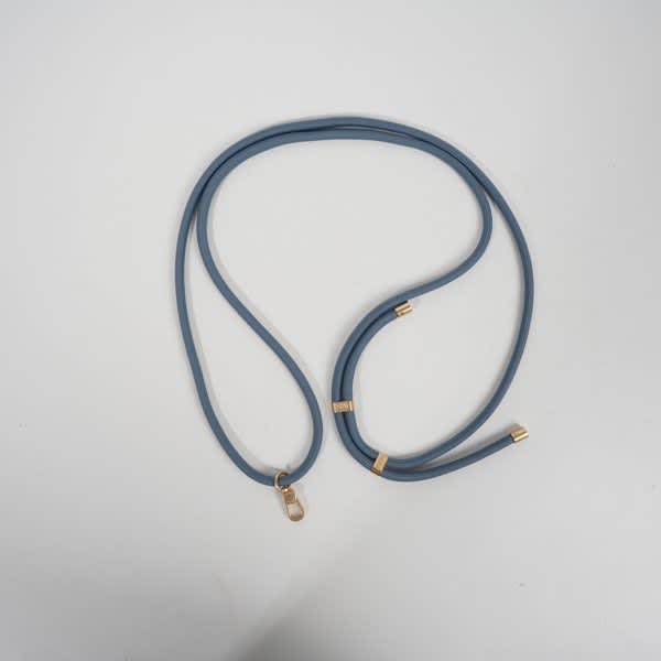 A blue adjustable crossbody lanyard with gold accents and a clip for attaching a cell phone. A blue adjustable crossbody lanyard with gold accents and a clip for attaching a cell phone.