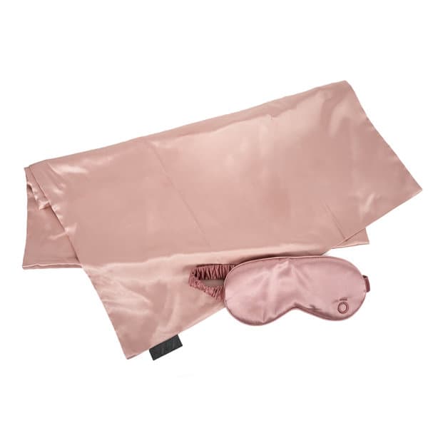 A satin pillowcase in rose pink paired with a matching sleep mask. The set features a logo on the mask. A satin pillowcase in rose pink paired with a matching sleep mask. The set features a logo on the mask.