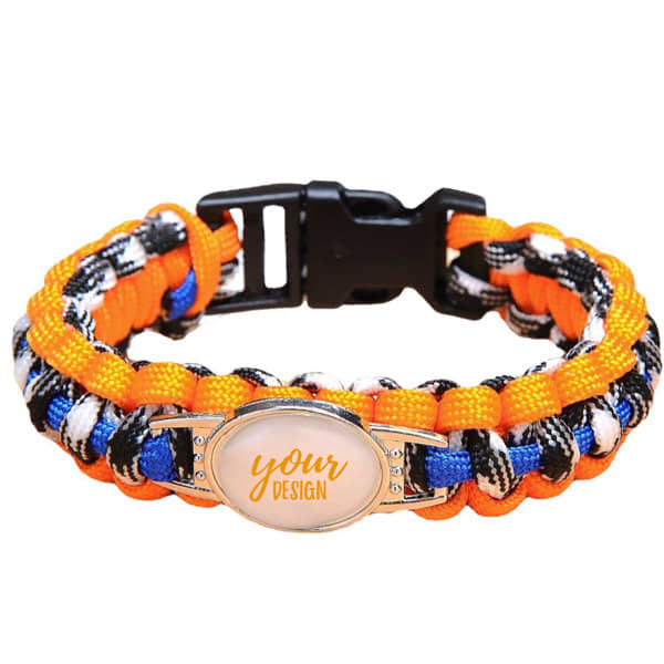 A custom woven paracord bracelet featuring orange, black, and blue colours with a logo space for personalised design. A custom woven paracord bracelet featuring orange, black, and blue colours with a logo space for personalised design.