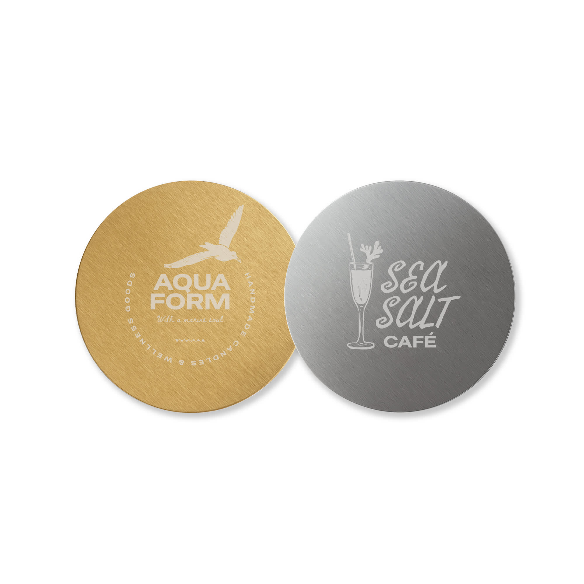 A round metal coaster featuring a gold finish on one side and a silver finish on the other, both with logos. Round Metal Coaster - Image 1