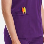 A purple women's top with a double V-neck and two pens in the pocket.
