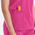 A pink women's double V-neck top with a pocket showing colourful pens.