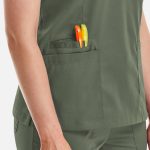 A green Matrix Women's Double V-Neck Top featuring two pens in the side pocket.