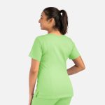 A woman is wearing a light green double V-neck top, showcasing a relaxed fit and short sleeves.