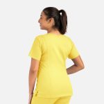 A woman in a bright yellow double V-neck top, showcased from the back, with a ponytail hairstyle.