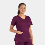 A woman in a purple double V-neck top with short sleeves and a pocket, featuring a logo.