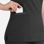 A black women's top with a double V-neck design, featuring a pocket and a hand inserting a white phone.