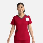 A red women's double V-neck top with a contrasting neckline, featuring a pocket and a badge holder.