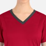 A red women's top featuring a double V-neck design with a contrasting grey trim and a logo on the neckline.