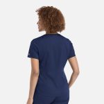 A women's tuckable V-neck top in navy, featuring a fitted design and a logo on the sleeve.