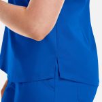A close-up of a vibrant blue women's V-neck top featuring a tuckable design and side slit. The top has a branding logo.
