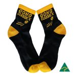 A pair of black quarter socks featuring colourful text and a logo.