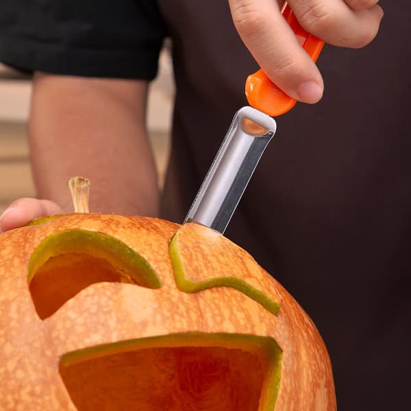 A pumpkin carving kit featuring a silver carving tool with an orange handle, used to shape a Halloween pumpkin. A pumpkin carving kit featuring a silver carving tool with an orange handle, used to shape a Halloween pumpkin.