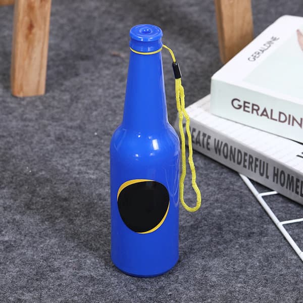 A blue drink bottle shaped like a beer bottle, featuring a black circular area and a yellow wrist strap. A blue drink bottle shaped like a beer bottle, featuring a black circular area and a yellow wrist strap.