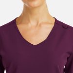 A close-up of a women's v-neck top in a rich purple colour featuring a metallic detail.