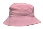 A pink terry towelling bucket hat with a soft texture and a wide brim. It features a logo.