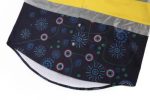 A Hawaiian shirt featuring a dark print with colourful patterns and a yellow reflective strip. It has a logo.