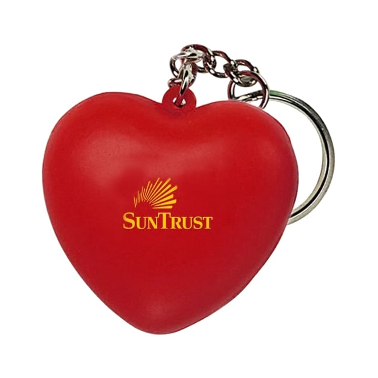 A red heart-shaped stress reliever attached to a metal keyring, featuring a logo. Keyring with Heart Stress Reliever - Image 1