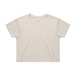 A light beige crop tee with a relaxed fit, featuring a simple design and a logo on the label.