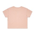 A light pink crop tee with short sleeves and a plain back. The shirt has a logo on the label.