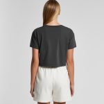A faded grey crop tee worn with white shorts, displayed from the back. The shirt features a branding logo.