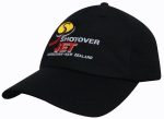 A black cap featuring a logo and text in red and yellow embroidery. The cap has a mesh design.
