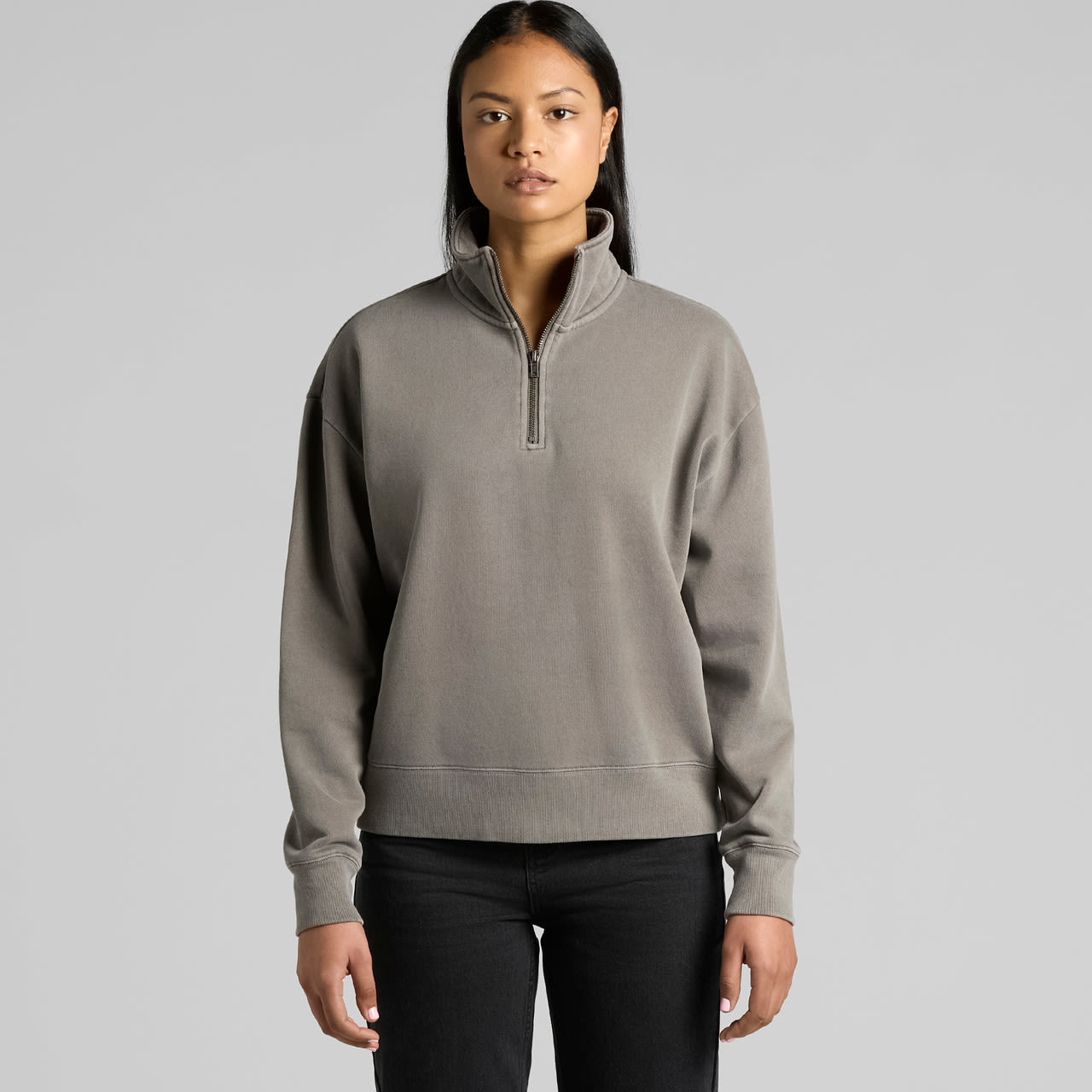 A grey half-zip jacket with a relaxed fit, featuring long sleeves and a collar. It has a subtle logo. A grey half-zip jacket with a relaxed fit, featuring long sleeves and a collar. It has a subtle logo.
