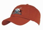 A rust-coloured cap with an embroidered logo on the front and a curved brim.