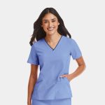 A women's V-neck top in light blue with short sleeves and a contrasting trim. Features a pocket on the side.