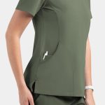 A women's V-neck top in olive green with a side pocket and a logo. The fabric appears smooth and fitted.