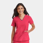 A women's V-neck top in vibrant pink with contrast trim. It features short sleeves and a side pocket.