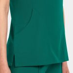 A women's v-neck top in a rich green colour, featuring a side pocket and a sleek design.