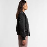 A black bomber jacket displayed on a model, featuring a sleek design and fitted silhouette.