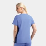 A women's mock wrap top in light blue with contrast navy panels and a logo.