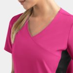 A women's mock wrap top in vibrant pink with contrast black panels, featuring a V-neck design.