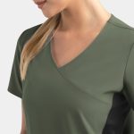 A women's mock wrap top in olive green with contrast panels, featuring a v-neck design. It includes a logo.