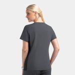A mock wrap top in a dark grey colour with contrast panels, featuring a woman from the back, showing a logo.