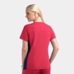 A women’s mock wrap top featuring contrast panels in red and navy. The top has a relaxed fit and short sleeves.