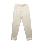 Track pants in a light cream colour with an elastic waistband and side pockets. Features a logo on the waistband.