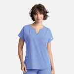 A women's dolman top in light blue with a V-neck, short sleeves, and a front pocket. It features branding.