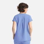 A relaxed-fit women's top in light blue with short sleeves and a back pleat. It features a logo on the side.