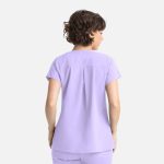 A lilac women's top featuring a back pleat and short sleeves, with a branding logo on it.
