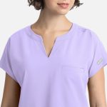 A lilac women's top with a V-neck, short sleeves, and a chest pocket, featuring a branding label.