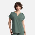A short-sleeved, green women's top with a V-neck and a small pocket, featuring a logo.