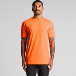 An orange work t-shirt with a simple design and a logo on the chest, displayed on a model.