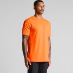 An orange work t-shirt featuring a crew neck and logoed branding, shown on a model with tattoos.