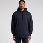 A navy hoodie with a front pocket and drawstrings at the hood, modelled by a man. The hoodie features a logo.