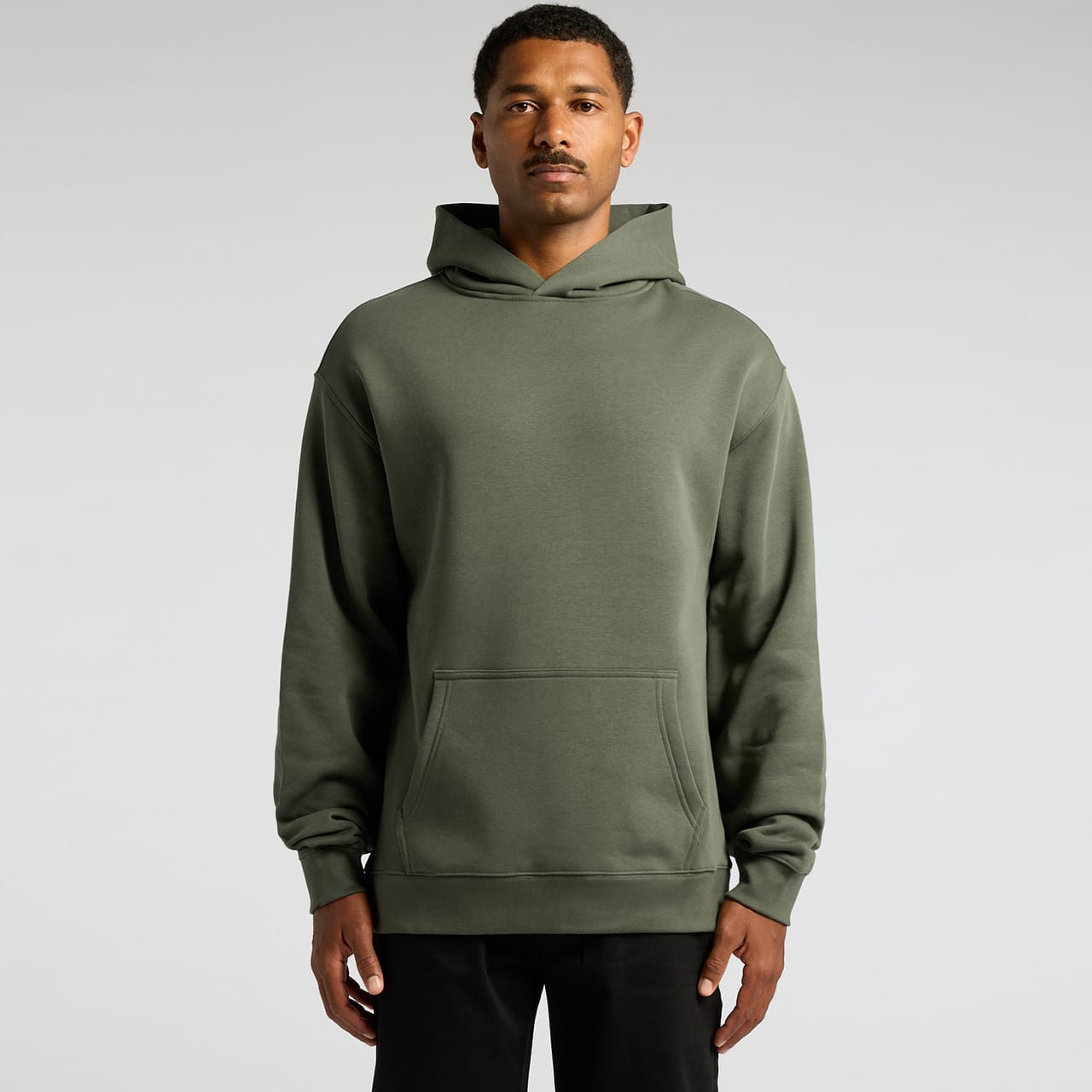 A green hoodie featuring a front pocket and a hood, worn by a model against a plain background. A green hoodie featuring a front pocket and a hood, worn by a model against a plain background.